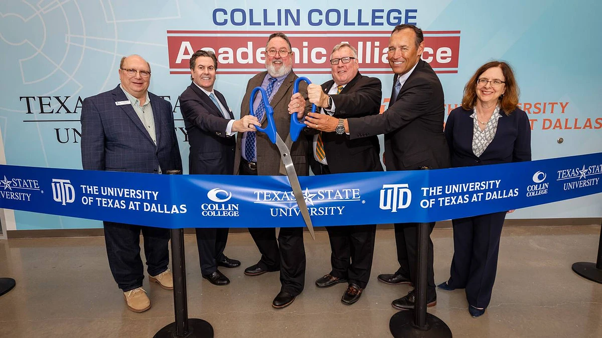 A group of people stand together smiling and holding oversized scissors during a ribbon-cutting ceremony for Collin College's Academic Alliance with Texas State University and The University of Texas at Dallas.