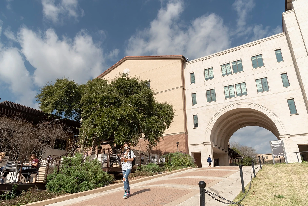 Photo of a student walking on campus